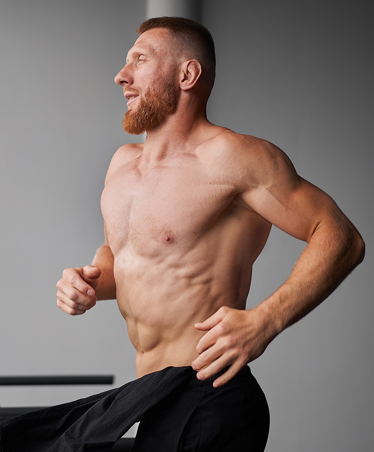 Smiling man in a black polo shirt.
