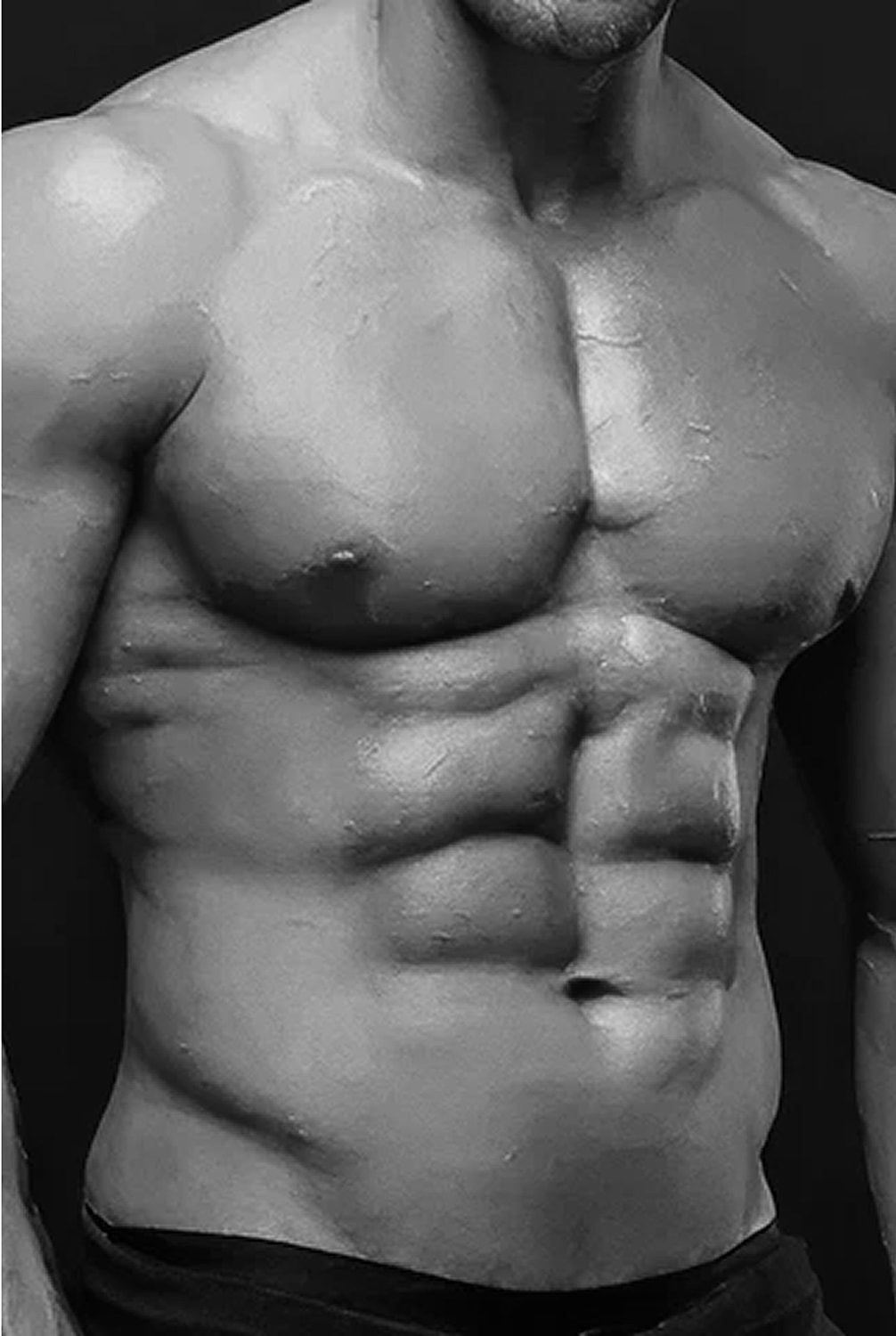Male torso showing muscular definition in black and white.