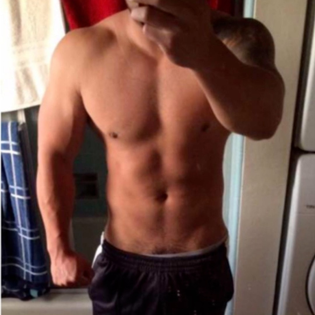 Shirtless person taking a mirror selfie.
