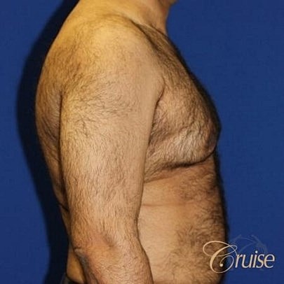 Smiling man in a black polo shirt.