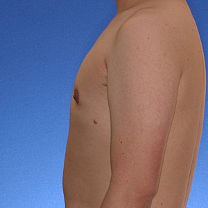 Profile view of a bare-chested male model.