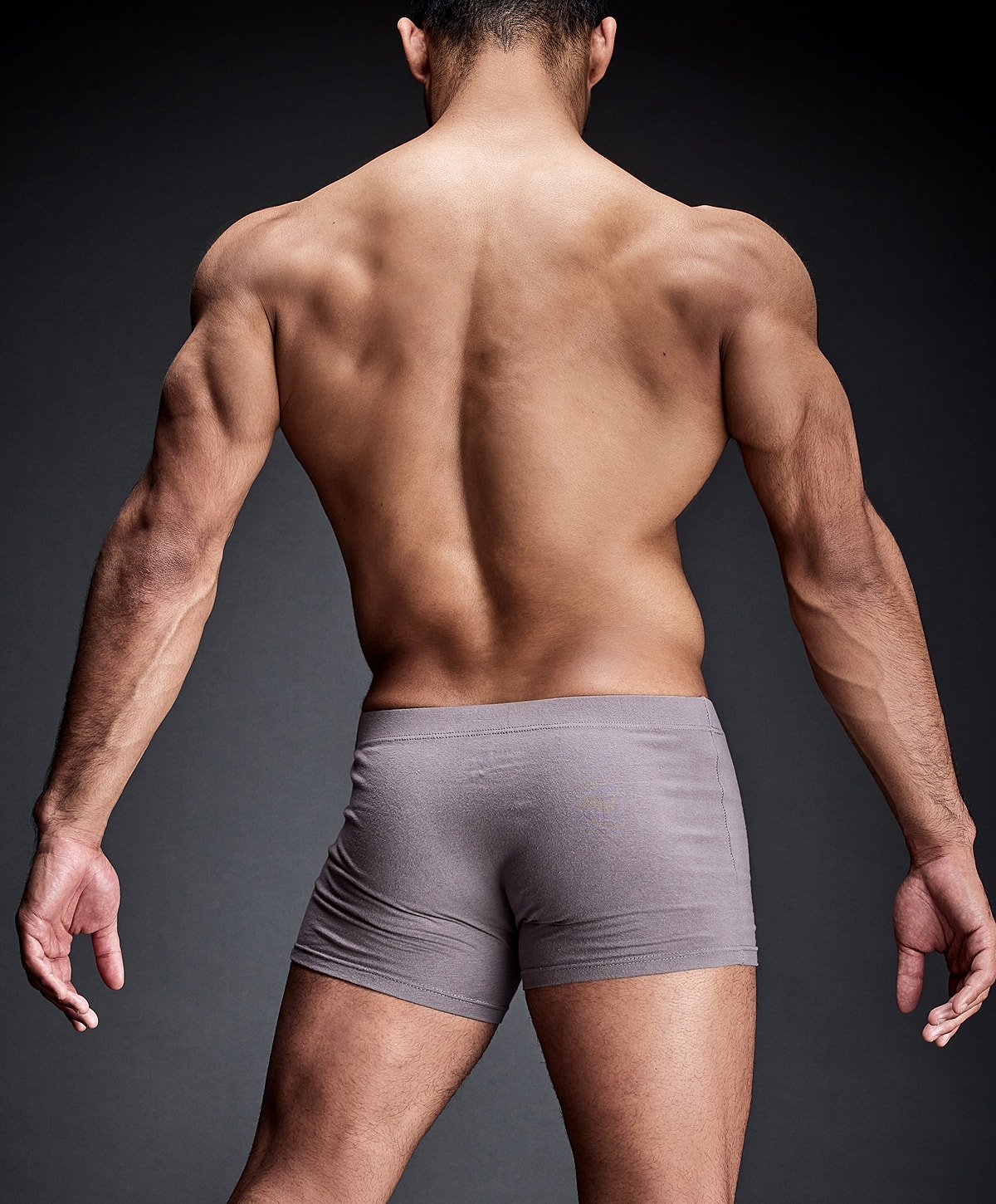 Smiling man in a black polo shirt.