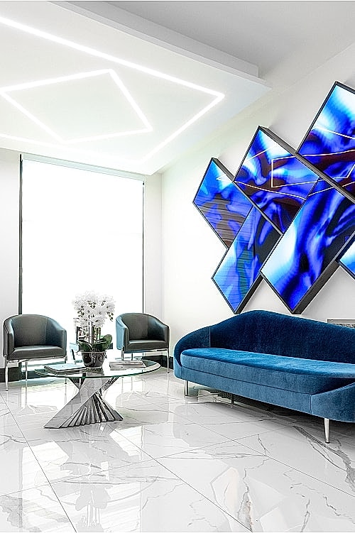 Modern lounge with blue accents and abstract artwork.