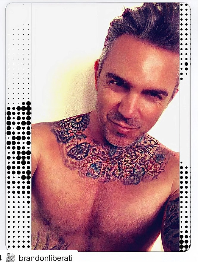 Shirtless man with colorful chest tattoos.