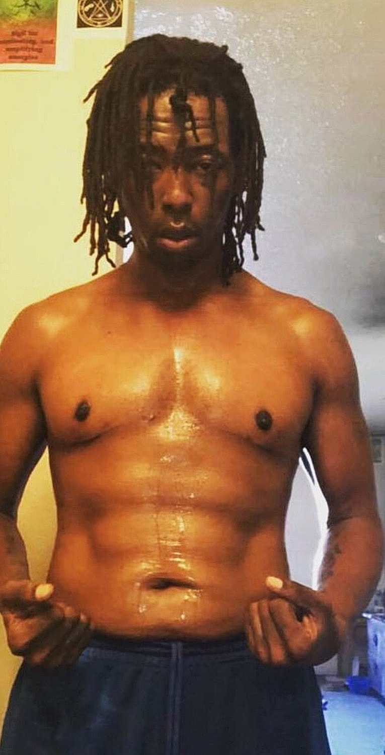 Shirtless man showing off his toned physique.