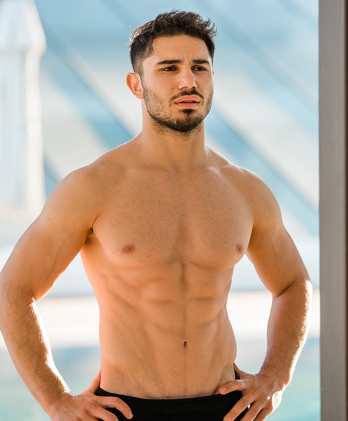 Smiling man in a black polo shirt.