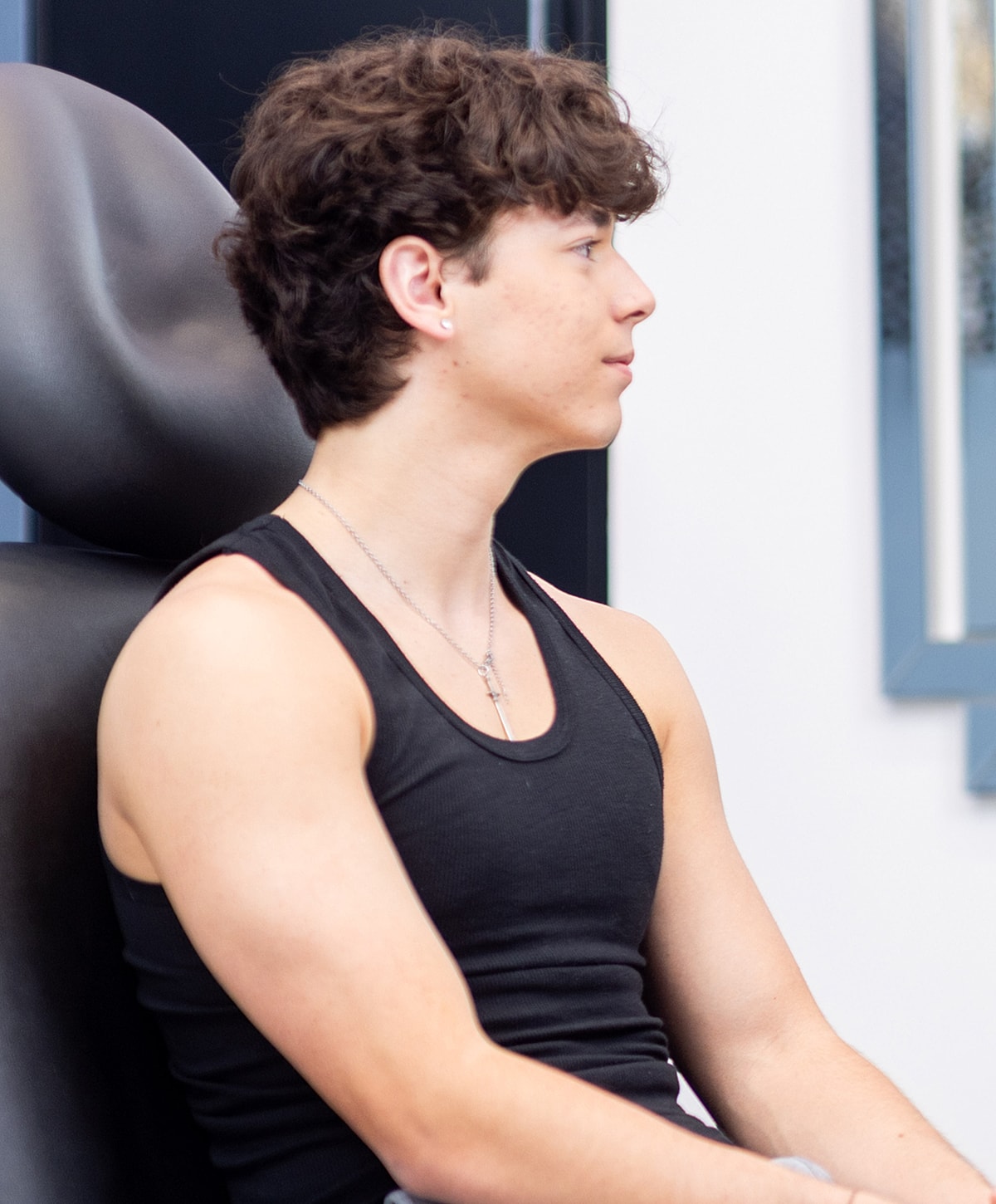 Smiling man in a black polo shirt.