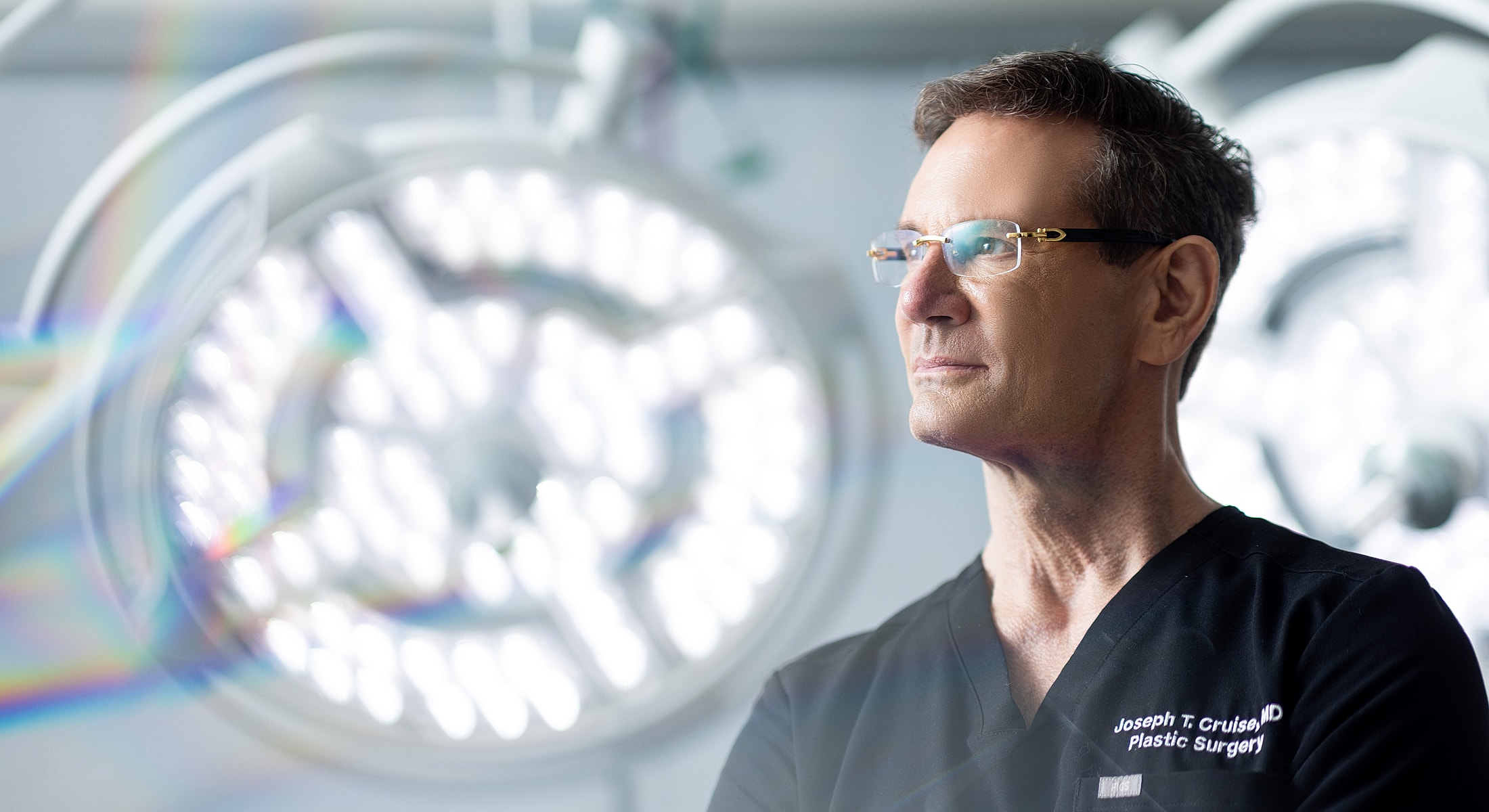 Surgeon in surgical environment, focused and professional.