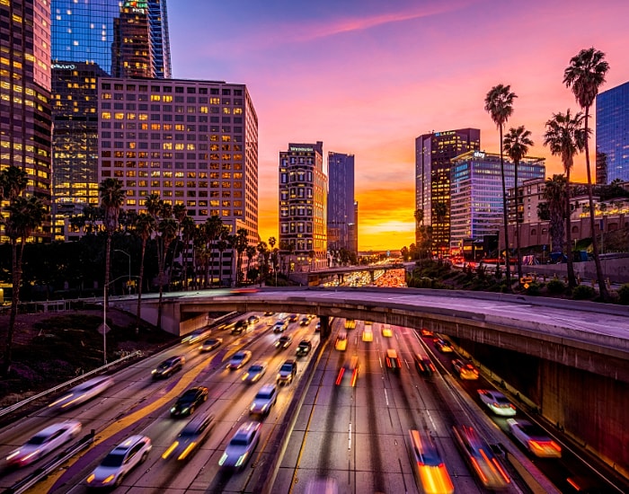 Los Angeles skyline at sunset with moving traffic
