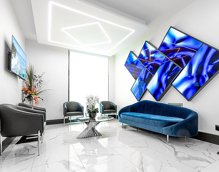 Modern waiting area with blue accents and lighting.