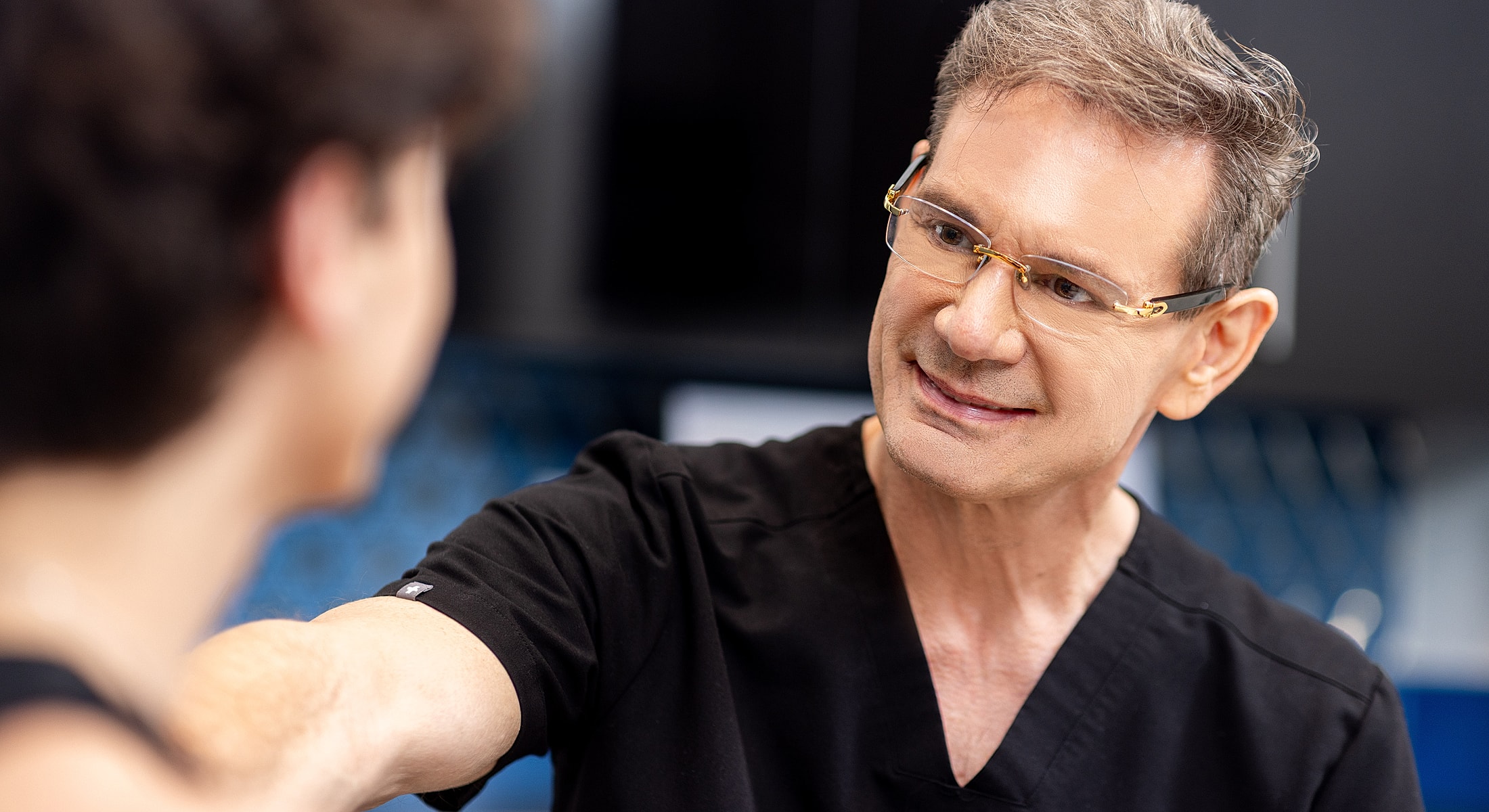 Doctor consulting with patient in a clinic setting.
