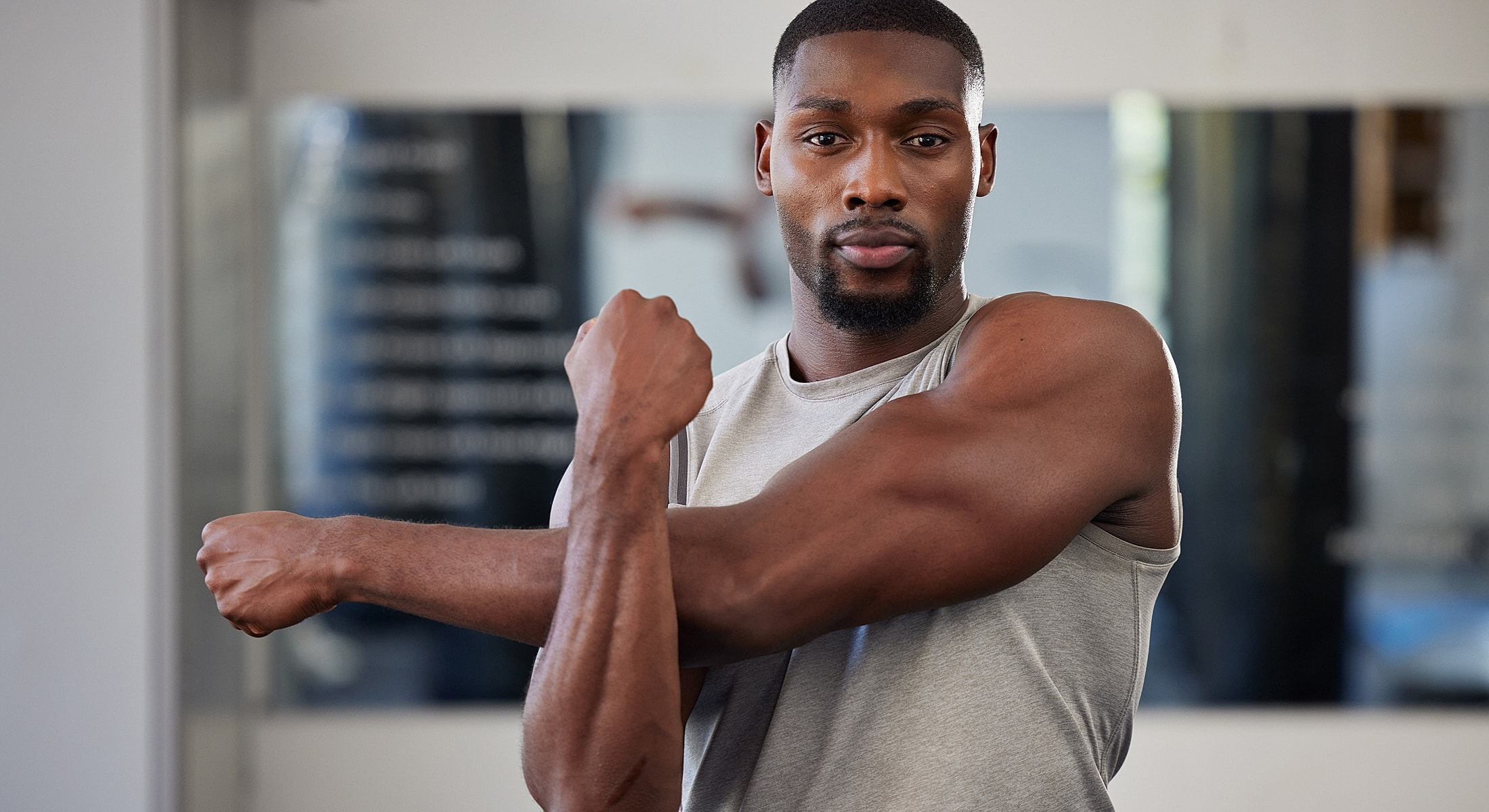 Male model posing against a bright background.