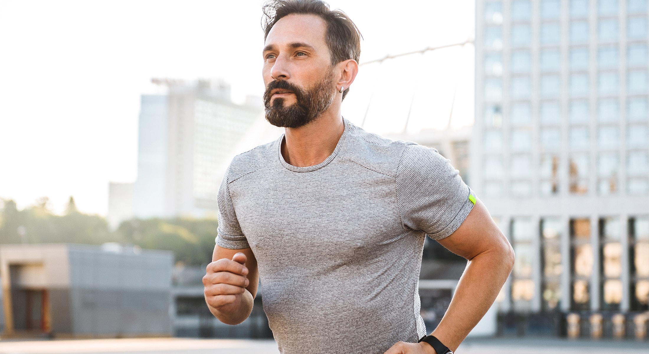 Man jogging outdoors in athletic attire.
