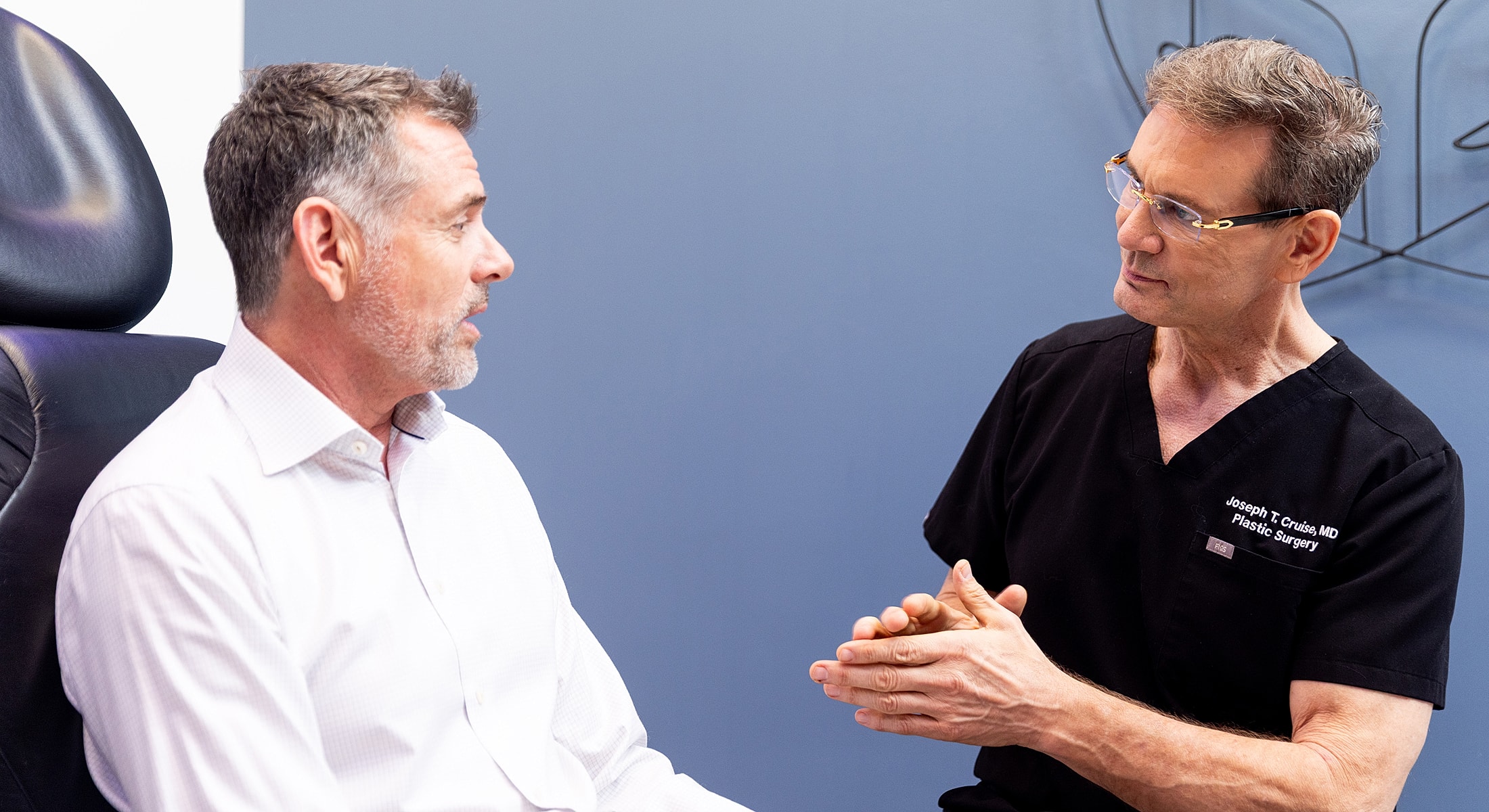 Consultation between doctor and patient in office.